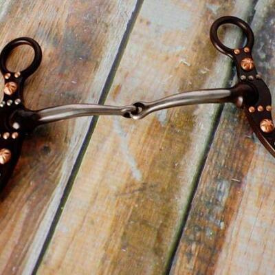48	

NEW Brown steel snaffle bit with engraved copper studs and silver accents on the cheeks.
brown steel snaffle bit with engraved...