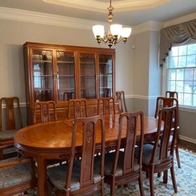 Gorgeous rosewood hand carved dining room set. Table 3 leaves 12 chairs with new cushions and matching hutch buffet complete set asking...