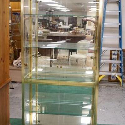 1042	POLISHED BRASS CURIO CABINET WITH INTERIOR LIGHT, 33 IN X 14 IN DEEP X 79 IN HIGH
