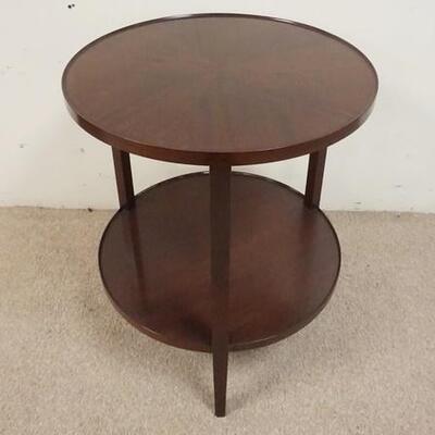 1059	2 TIER ROUND MAHOGANY LAMP TABLE, BOOK MATCHED VENEER TOP. DAMAGE TO SECTION OF TOP TRIM, 24 IN X 29 IN HIGH
