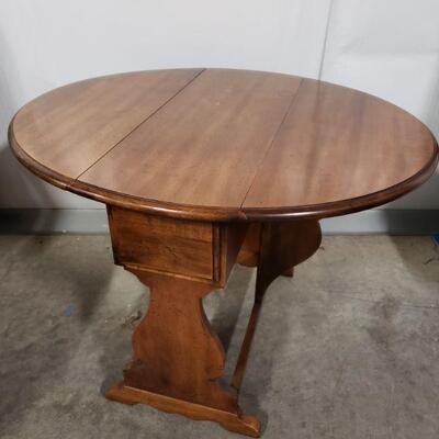 Maple drop leaf table with small drawer. Measures 23 1/2