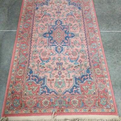 Coral and cranberry colored Karastan rug is 100% wool and measures 34