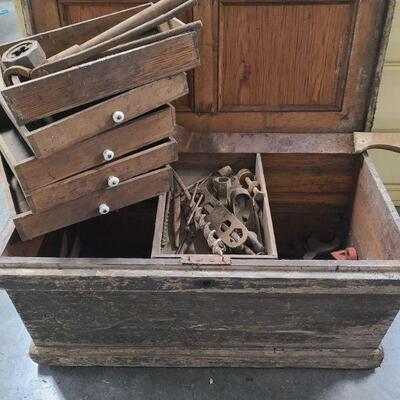 Very old, most likely antique wood tool box has stacking drawers for organizing tools. Toolbox has 7 storage areas, the bottom large area...