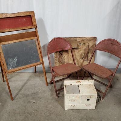 Vintage Durham 3 piece metal table and chairs and a fun chalkboard easel. Chairs are red metal and pretty rusty. Table has a cloth fabric...