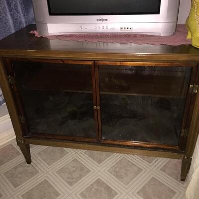 All wood console tv cabinet repurposed into a cabinet with glass doors & a shelf