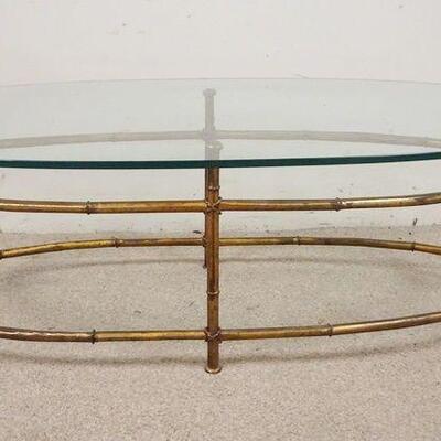 1295	OVAL GLASS TOP COFFEE TABLE, IRON BASE, 54 IN X 26 1/4 IN X 16 3/4 IN HIGH
