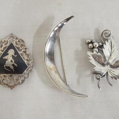 1289	LOT OF THREE STERLING SILVER BROOCH PINS. LOT INCLUDES A LEAF PIN MARKED TAXCO, A CRESCENT MARKED DENMARK & ONE MARKED SIAM....