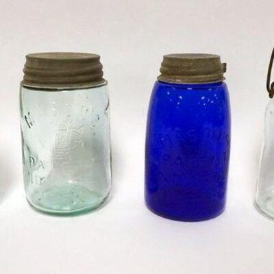 1030	4 CANNING JARS INCLUDING COBALT BLUE MASON, 3 W/ ZINC LIDS ONE W/ GLASS LID TALLEST IS 6 1/2 IN H. LOT ALSO INCLUDES A TELEPHONE...