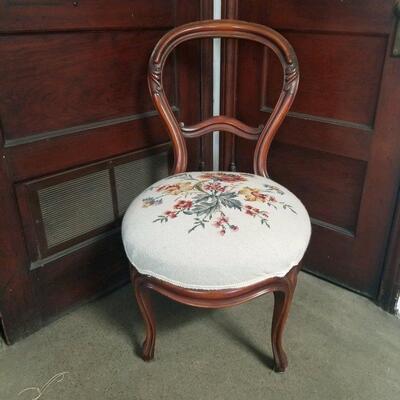 Antique carved mahogany needlepoint chair in excellent condition.