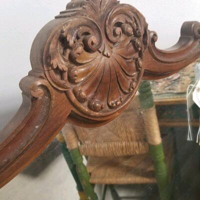 top detail on large carved wood framed vintage mirror