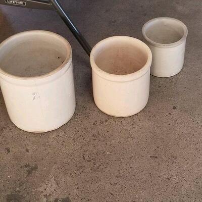 three vintage/antique crocks, largest one has 2 printed on it (2 gallon pot?)