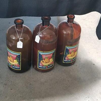 Three vintage large fruit syrup bottles
