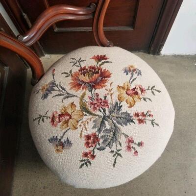 Detail of needlepoint on cushion of mahogany chair