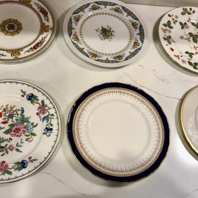 Tons of mix and match China dinner plates, salad plates and bread dishes make for an eclectic dining table setting.