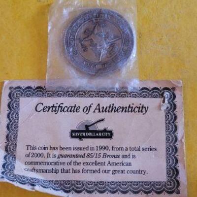 Silver dollar and certificate of authenticity