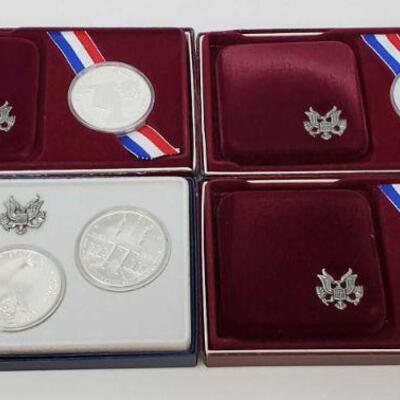 810	

2 1984 Olympic Silver Dollars, 1983 Olympic Silver Dollar, and Uncirculated Olympic Silver Dollars 1984 Collector Set 