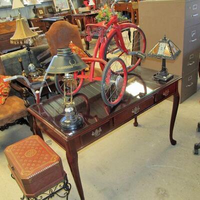 Nice mahogany desk w/ glass top & 1940s tricycle.
