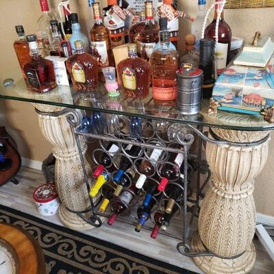 Look past the liquor bottles and there is a very nice table with a thick glass top