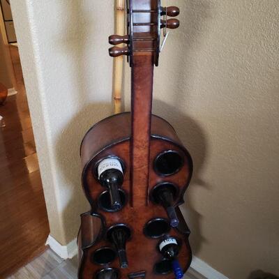 This is a wine bottle holder that looks like a cello