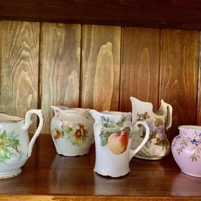 small assortment of porcelain creamers