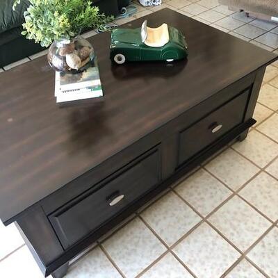 Lift top coffee table with hidden storage. Great for enjoying a meal in front of the TV and for storing blankets, pillows and more. Two...