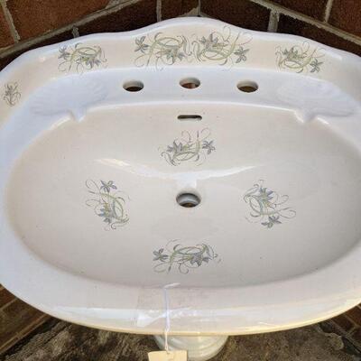 Large pedestal sink with hand-painted flowers on sink and  base,