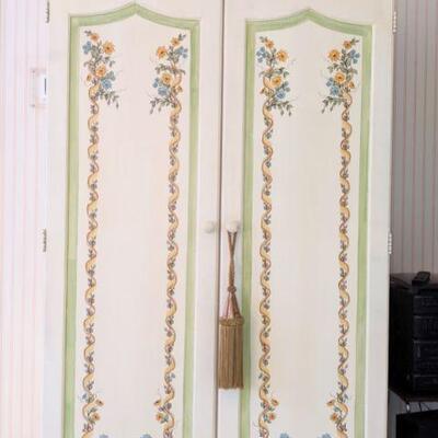 Entertainment armoire, holds tvs, stereo, books etc hand-painted. Doors reticulate fold back against the sides.