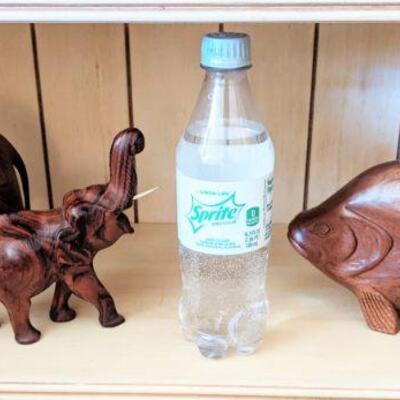 Pair of hand-carved elephants and fish, Sprite bottle to show size