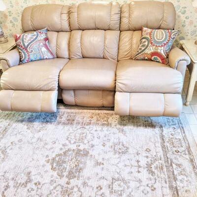 Dual reclining beige leather lazy boy sofa. Tag still attached