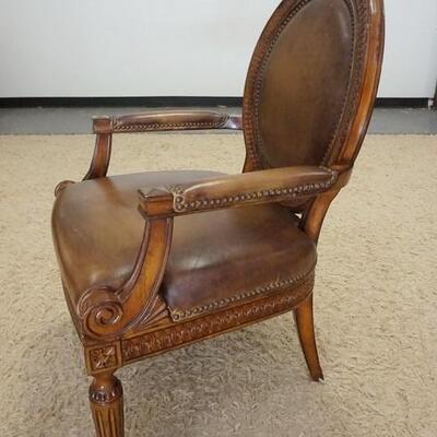 1011	CARVED MEDALLION LEATHER BACK ARM CHAIR. 27 IN W, 40 IN H 
