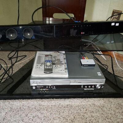 LG -Sound Bar & Panasonic DVD/VHS Player Glass Tv Stand
