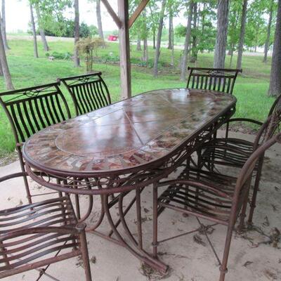 Really nice patio table with 6 chairs- bring some muscle to move this thing it is HEAVY!