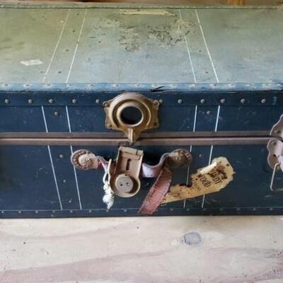 Vintage metal footlocker trunk with brass and leather detailing. Large latch is broken, trunk measures 30x17x12