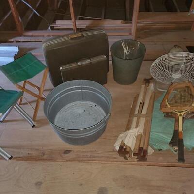 Miscellaneous lot of attic treasures. Vintage suitcases, golf seats, tennis rackets, cot, fan and large wash basin 22x11