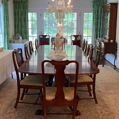 Beautiful wood mahogany dining table. With two leaves, it expands to banquet size. Triple pedestal design with ball and claw feet. Full...