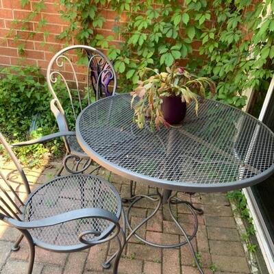 Wrought iron bistro set with 4 chairs and side table