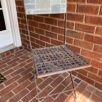 This is a metal and tile framed chair. Has a mesh design for a sturdy seat. There are a few spots showing rust. 15.5x17x34...