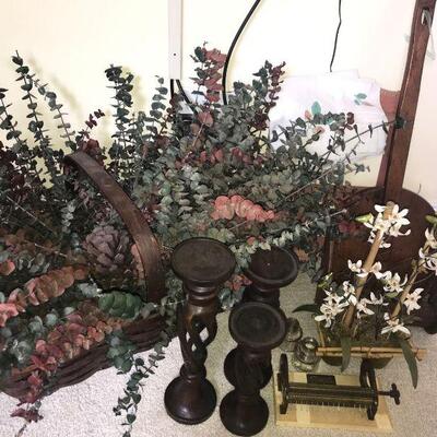 This lot contains a variety of household decor items including a basket with faux flowers, hanging shelves, candle holders, little faux...
