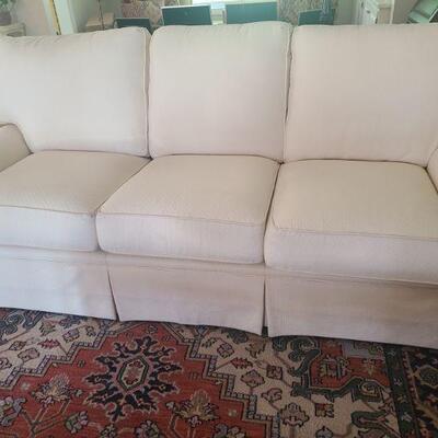 Cream colored sofa is coming from a cat friendly home. Sofa is in good condition, just has some small spots on it. Measures 87