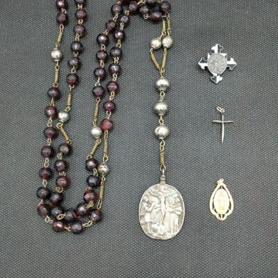 1- Rosary, not sure of metal, but beautiful medallion, 2- Mary 14 KT Gold medallion, weighs 2g, 3- sterling cross medallion, weighs less...