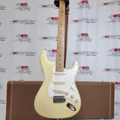 2034	

Fender Stratocaster Electric Guitar With Hard Case
Serial Number: V071062. Stand Not Included. Year is believed to be 2000 based...