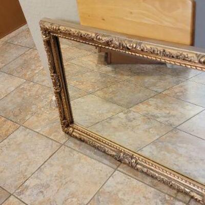 large mirror with beautiful carved wooden frame