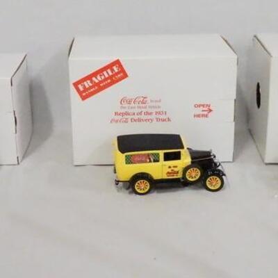 1157	LOT OF THREE DELIVERY TRUCK DIE CAST REPLICAS FROM THE DANBURY MINT. LOT INCLUDES A 1930S MILK TRUCK, A 1931 COCA COLA DELIVERY...