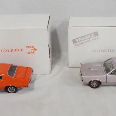1142	LOT OF TWO  DIE CAST 1:24 SCALE PONTIAC GTO MODELS FROM THE DANBURY MINT. LOT INCLUDES A 1969 PONTIAC GTO JUDGE & A 1965 PONTIAC...