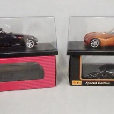 1263	LOT OF TWO DIE CAST 1:18 MODEL CARS IN DISPLAY CASES W/ ORIGINAL BOXES. LOT INCLUDES PLYMOUTH PROWLER & DODGE CONCEPT VEHICLE 
