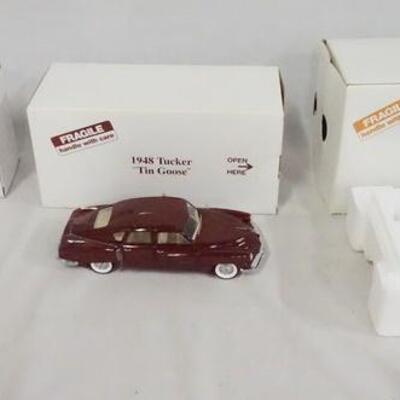 1156	LOT OF THREE DIE CAST 1:24 SCALE MODEL CARS FROM THE DANBURY MINT. LOT INCLUDES; 1935 DEUSENBERG SSJ, 1948 TUCKEY *TIN GOOSE* &...