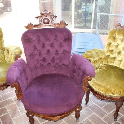 Victorian parlor chairs; one aubergine gentleman's chair and two chartreuse lady's chairs