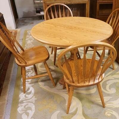1184	S BENT BROTHER ROUND OAK TABLE & FOUR CHAIRS. 42 IN HAS TWO 11 3/4 IN  LEAVES. CHAIRS HAVE HOOP ARROW BACKS 
