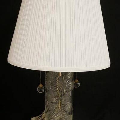 1260	CUT CRYSTAL LAMP W/ BRASS BASE HAS FACETED CRYSTAL BALL FINIAL & PULLS & A PLEATED CLOTH SHADE. 31 IN H 
