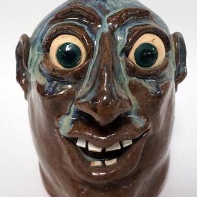 1162	TIM FLINN GROTESQUE FACE JUG, JUG WITH MULTI COLOR DRIP GLAZE, SIGNED AND DATED ON BOTTOM, 2001, 9 IN HIGH
